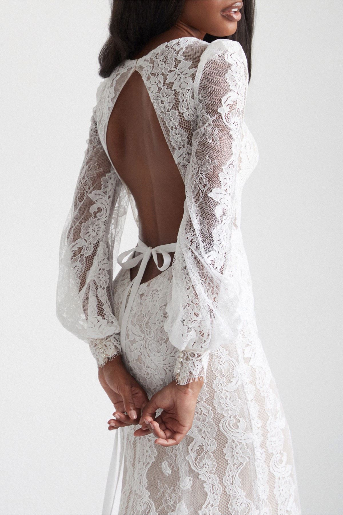 Model wearing white dress by Watters