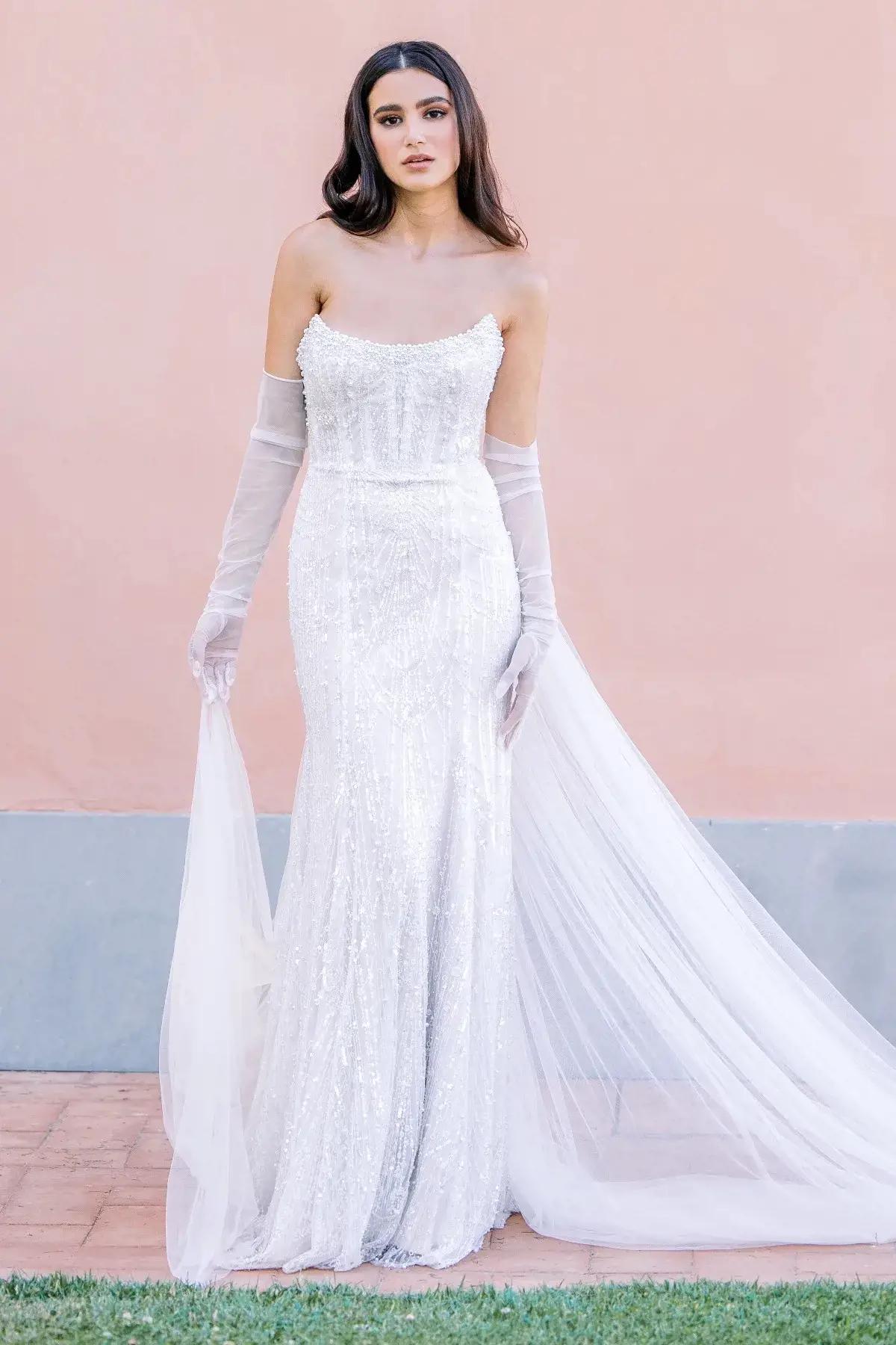 Model wearing white dress by Watters
