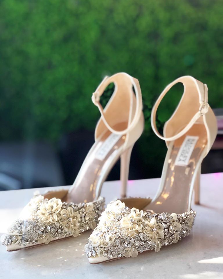 A pair of wedding shoes with 3D flowers and rhinestones